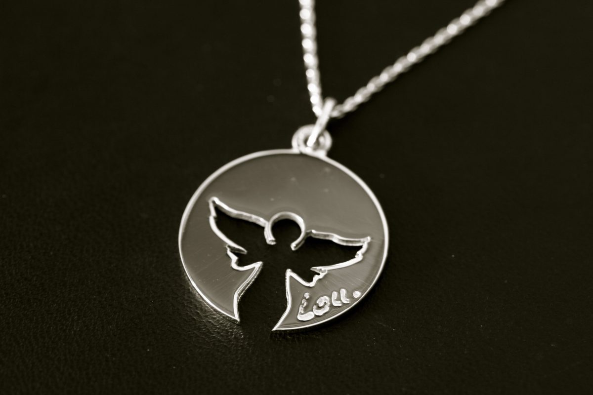 Médaille "Un Ange Passe". Or gris